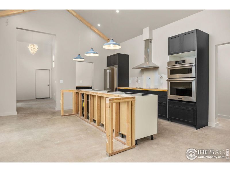 Open kitchen design - kitchen island to be completed with matching wood countertops Open kitchen design - kitchen island to be completed with matching wood countertops