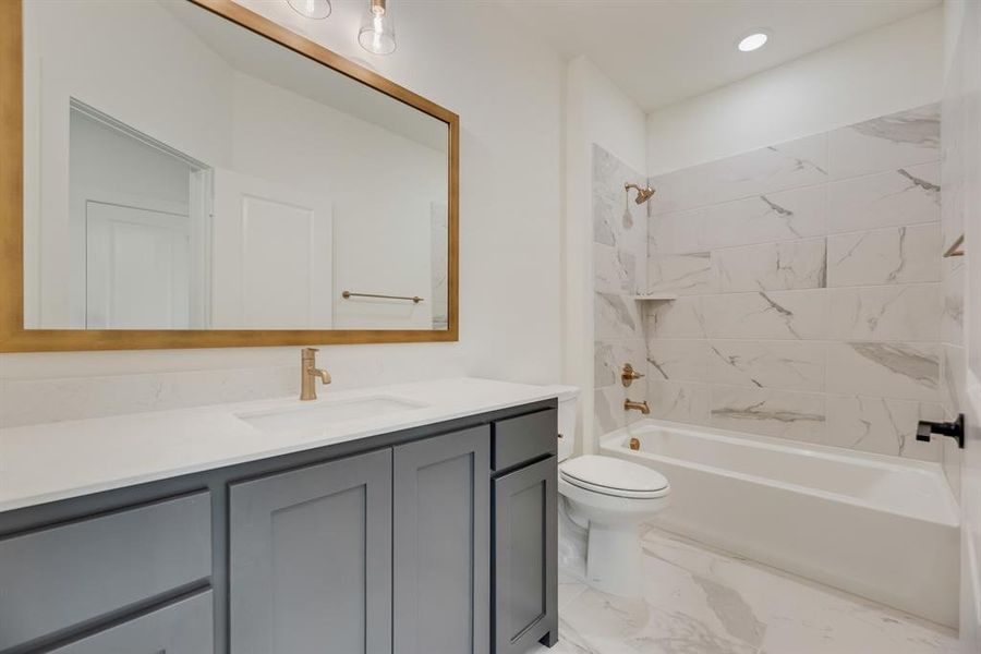 Bathroom with shower / bath combination, vanity, light marble finish floors, and recessed lighting Bathroom with shower / bath combination, vanity, light marble finish floors, and recessed lighting