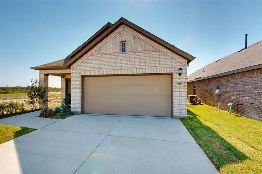 Front exterior of a new home in Meadow Park, Ponder, TX, highlighting curb appeal (Image 18). Front exterior of a new home in Meadow Park, Ponder, TX, highlighting curb appeal (Image 18).