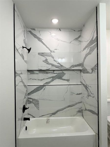 Bathroom featuring tiled shower / bath