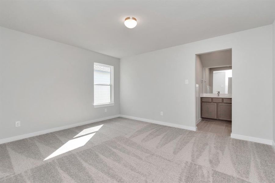 Secondary bedroom features plush carpet, custom paint, large window with privacy blinds and access to the Jack and Jill bath. Sample photo of completed home with similar floor plan. Actual colors and selections may vary.