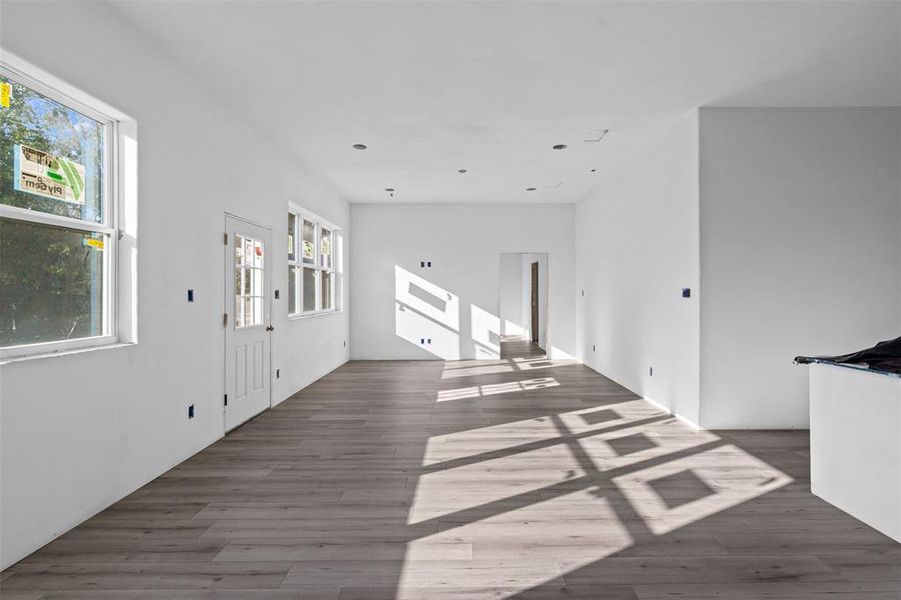 Unfurnished living room featuring wood finished floors Unfurnished living room featuring wood finished floors