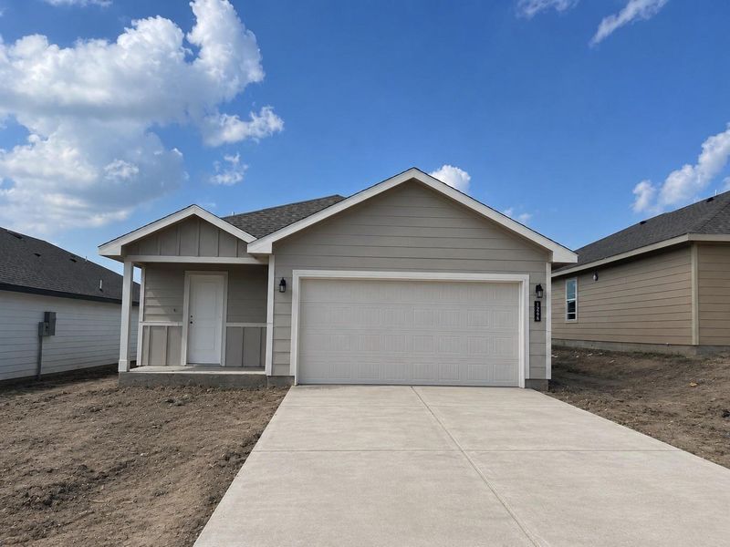 Front exterior of a new home in Wilkins Valley, Brenham, TX, highlighting curb appeal (Image 1). Front exterior of a new home in Wilkins Valley, Brenham, TX, highlighting curb appeal (Image 1).