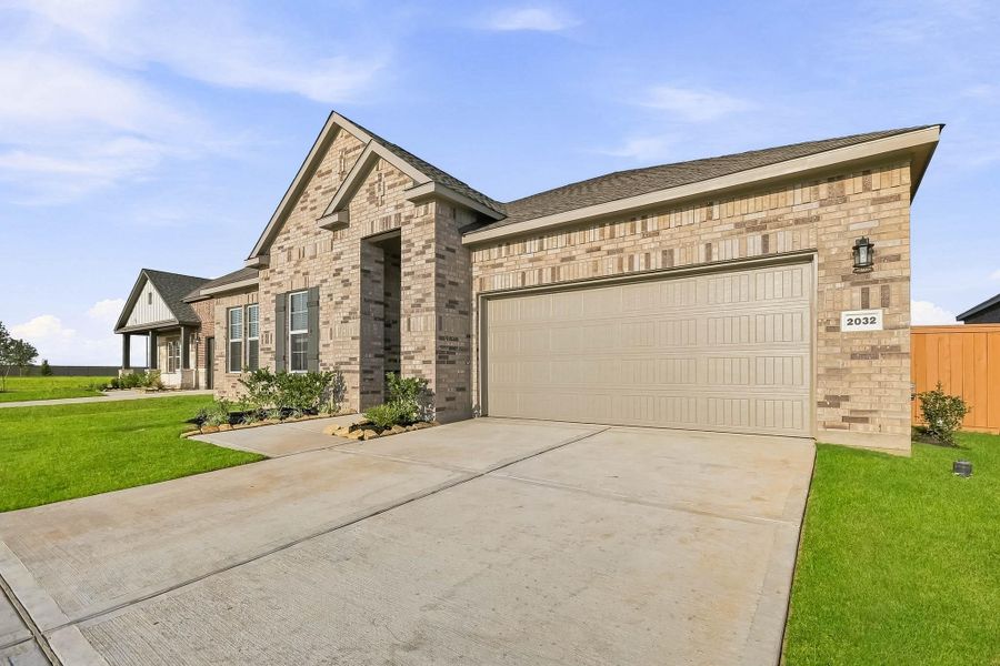 Front exterior of a new home in Sunterra Lakes, Brookshire, TX, highlighting curb appeal (Image 1). Front exterior of a new home in Sunterra Lakes, Brookshire, TX, highlighting curb appeal (Image 1).