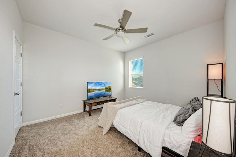 Bedroom with carpet and a ceiling fan