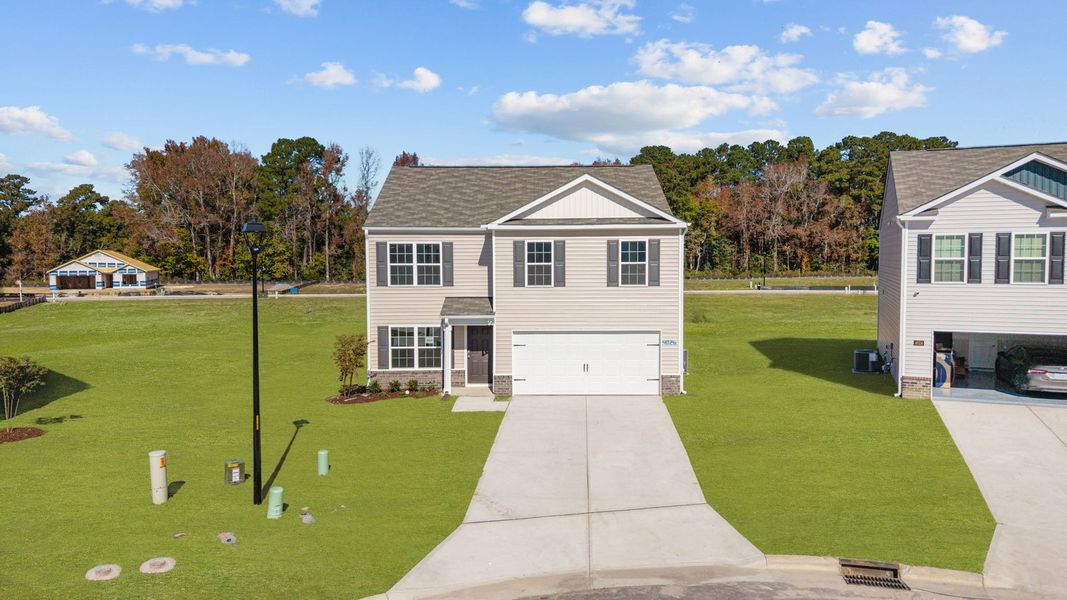 Front exterior of a new home in Madeline Farm, New Bern, NC, highlighting curb appeal (Image 2).