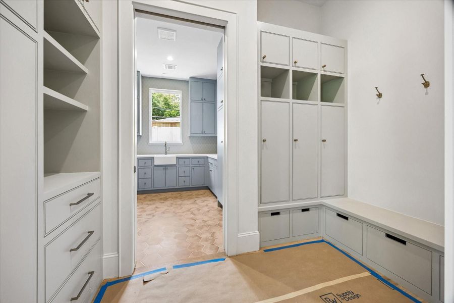 The mudroom and utility area are separated by pocket doors, offering added privacy and functionality