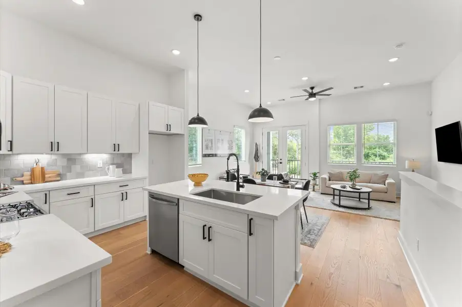 This stylish kitchen island anchors the heart of the home, offering clear sightlines to the adjacent living area and out through elegant French doors to the balcony. Positioned for both function and connection, the island features sleek countertops, bar seating, and pendant lighting that adds a touch of sophistication. This stylish kitchen island anchors the heart of the home, offering clear sightlines to the adjacent living area and out through elegant French doors to the balcony. Positioned for both function and connection, the island features sleek countertops, bar seating, and pendant lighting that adds a touch of sophistication.
