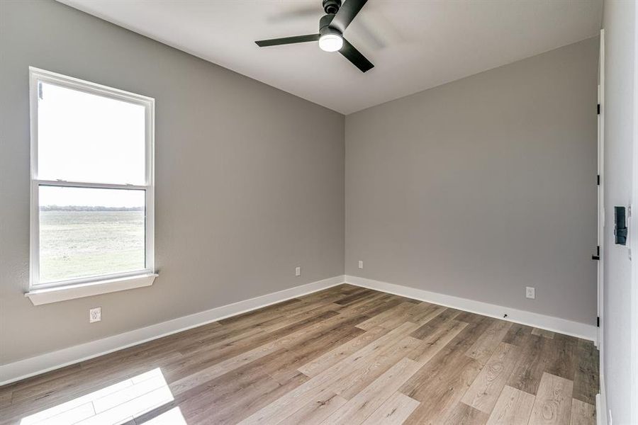 Spare room featuring light hardwood / wood-style floors and ceiling fan