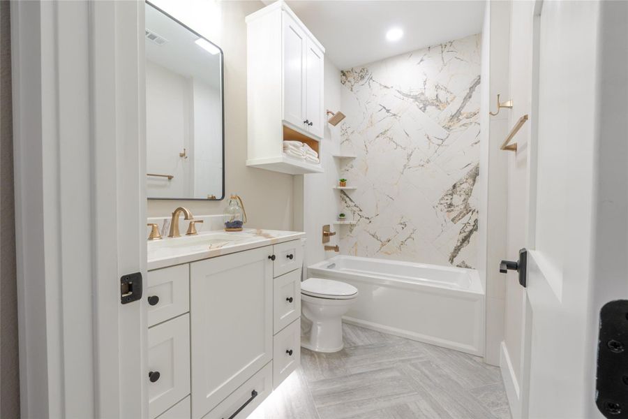 Full bath featuring vanity, shower / bathtub combination, recessed lighting, and parquet floors
