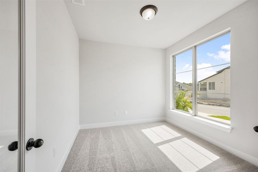 Carpeted empty room featuring baseboards Carpeted empty room featuring baseboards