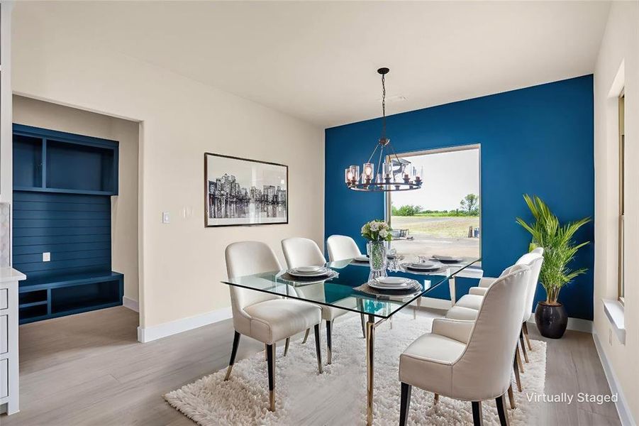 Dining space with a chandelier and wood finished floors Dining space with a chandelier and wood finished floors