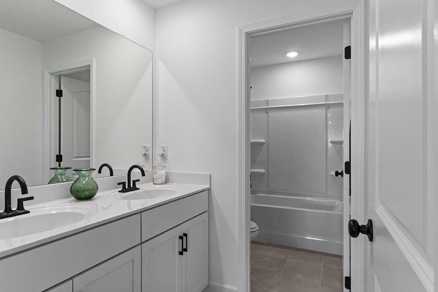A bathroom with a sink and a shower.