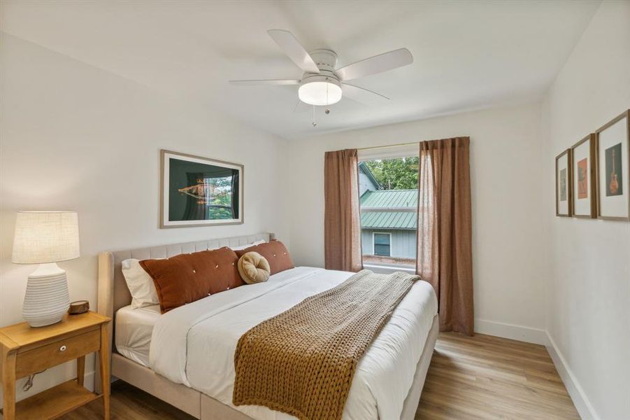 Bedroom with ceiling fan and hardwood / wood-style floors
