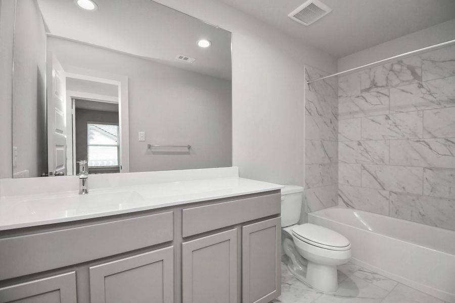 Modern secondary bath. Sample photo of completed home with similar floor plan. As-built interior colors and selections may vary. Modern secondary bath. Sample photo of completed home with similar floor plan. As-built interior colors and selections may vary.