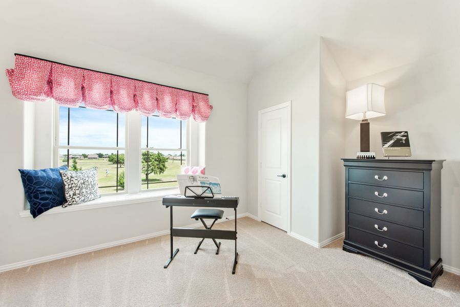 Bedroom with window seat, keyboard piano, dark dresser, and red valance curtains over a large window