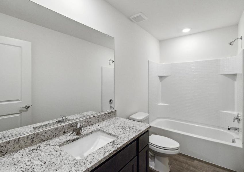 Secondary bathroom with a dual shower and tub.