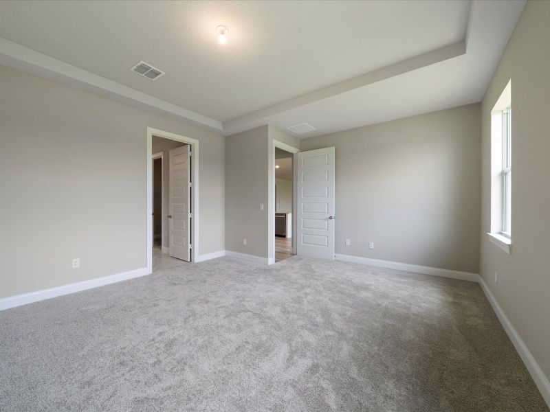 Primary Bedroom in the Coral floorplan at 6295 NW Sweetwood Drive in Brystol at Wylder