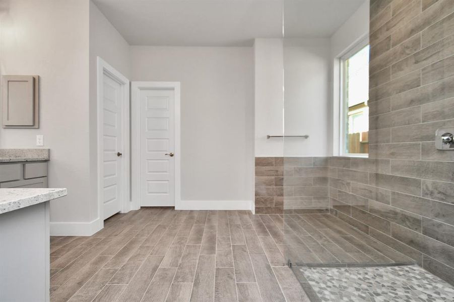 Escape to a spa-like oasis in this primary bathroom. Sample photo of completed home with similar plan. As built color and selections will vary.