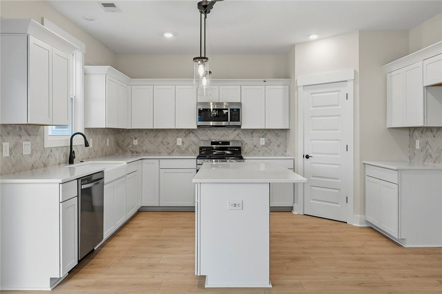 Gleaming stone countertops and shaker cabinetry fr