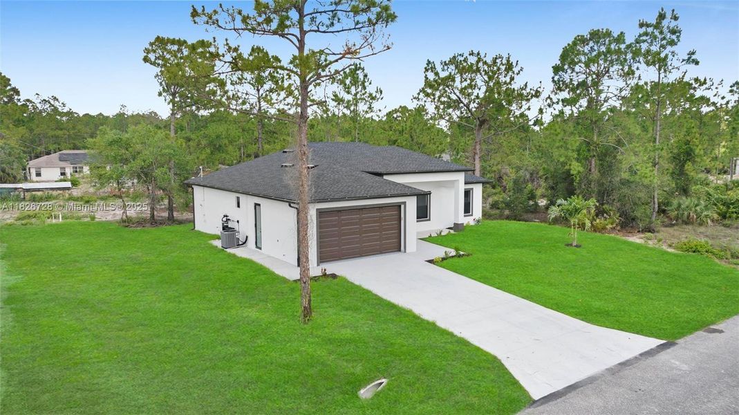 Front exterior of a new home in , Lehigh Acres, FL, highlighting curb appeal (Image 10).