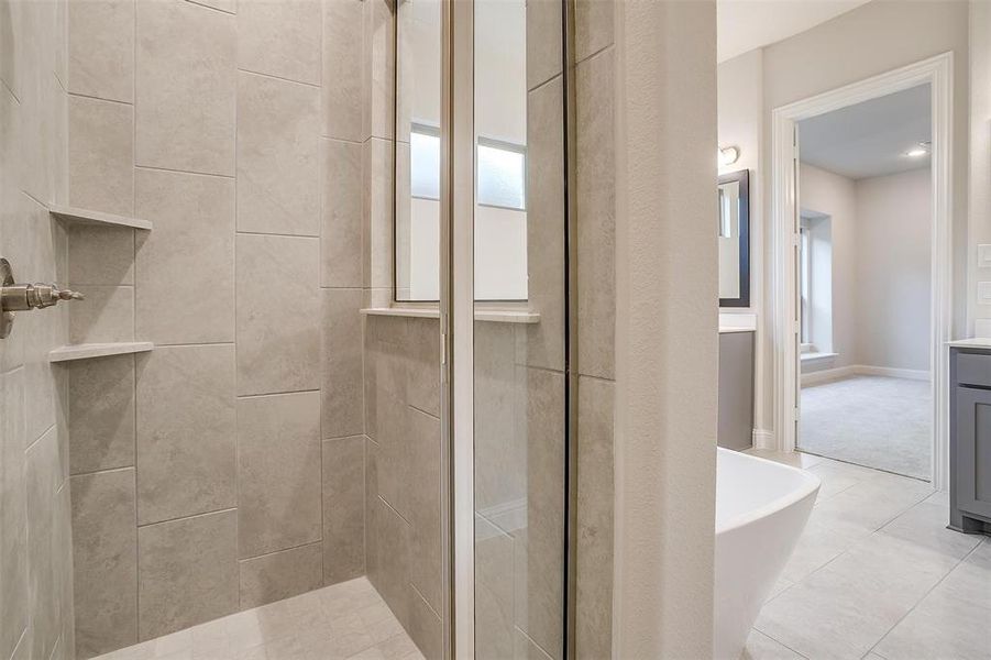 Bathroom with vanity, a wealth of natural light, tile patterned flooring, and shower with separate bathtub