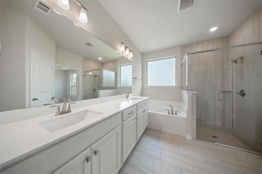 Full bath with a bath, a shower stall, double vanity, tile patterned flooring, and recessed lighting