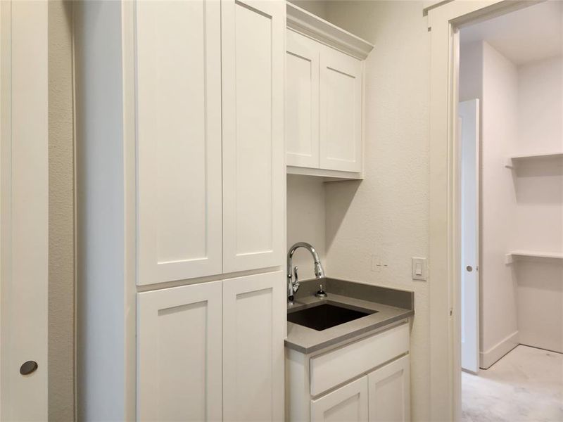 Laundry room to Master Closet. Cabinets and Sink