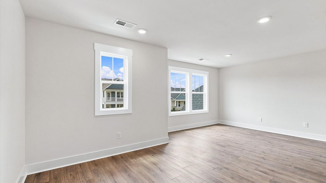 First-class loft showcasing hardwood floors and an adaptable space for every stage of life