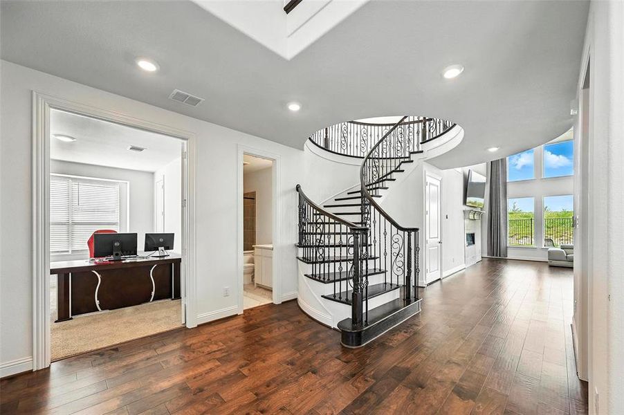Entrance foyer featuring hardwood / wood-style floors, stairway, and recessed lighting
