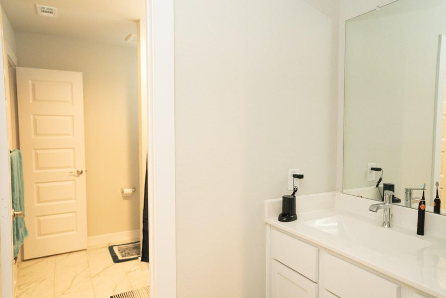 Furnished interior view inside a new home in Sunterra, Katy (Image 35).