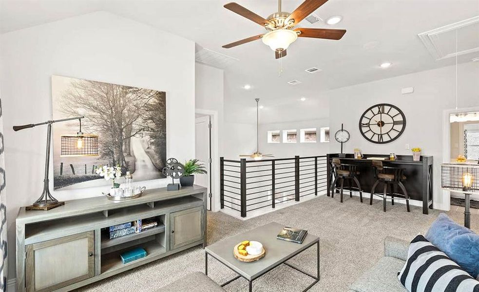 Carpeted living room with ceiling fan