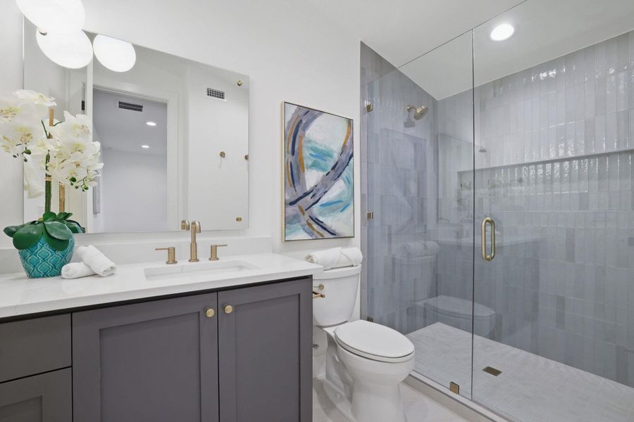 Bathroom with vanity, a stall shower, and recessed lighting