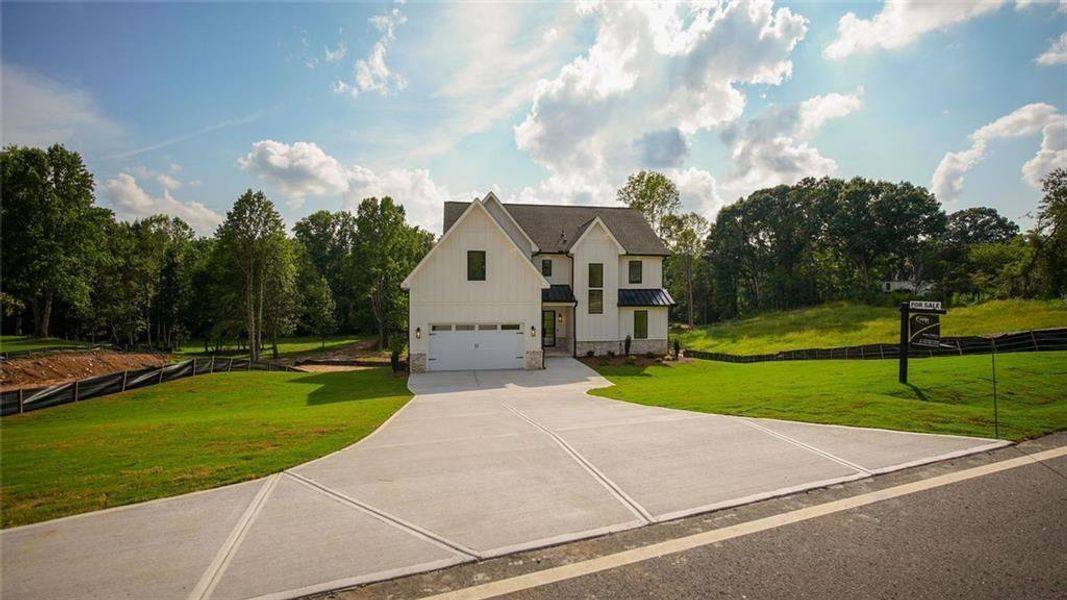 Front exterior of a new home in , Flowery Branch, GA, highlighting curb appeal (Image 27).