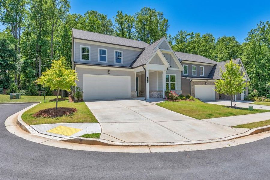 Front exterior of a new home in , Holly Springs, GA, highlighting curb appeal (Image 26). Front exterior of a new home in , Holly Springs, GA, highlighting curb appeal (Image 26).