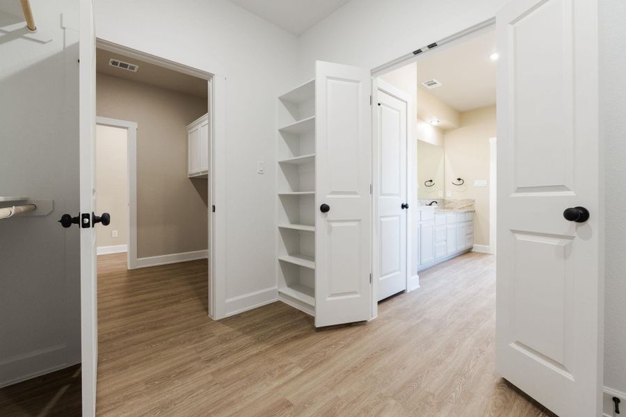 Walk in closet featuring light wood-style floors