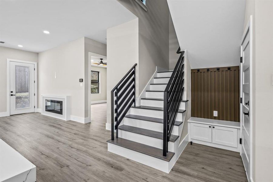 Stairs with ceiling fan and wood-type flooring
