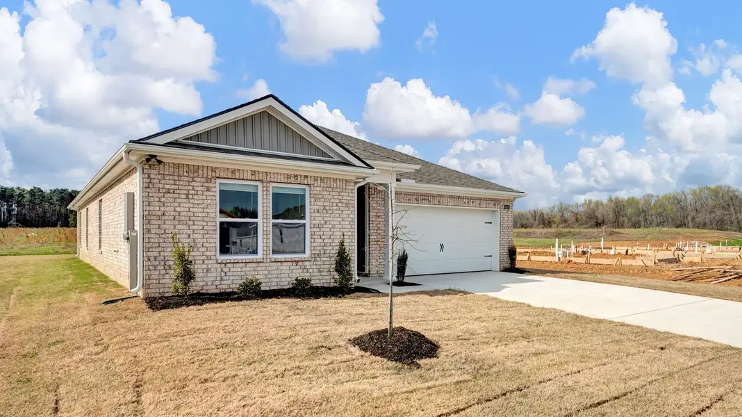 Front exterior of a new home in Huntington Estates, Millington, TN, highlighting curb appeal (Image 2).