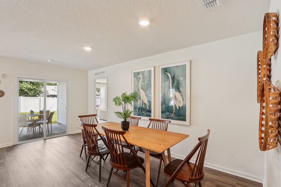 A dining room with a table and chairs. A dining room with a table and chairs.