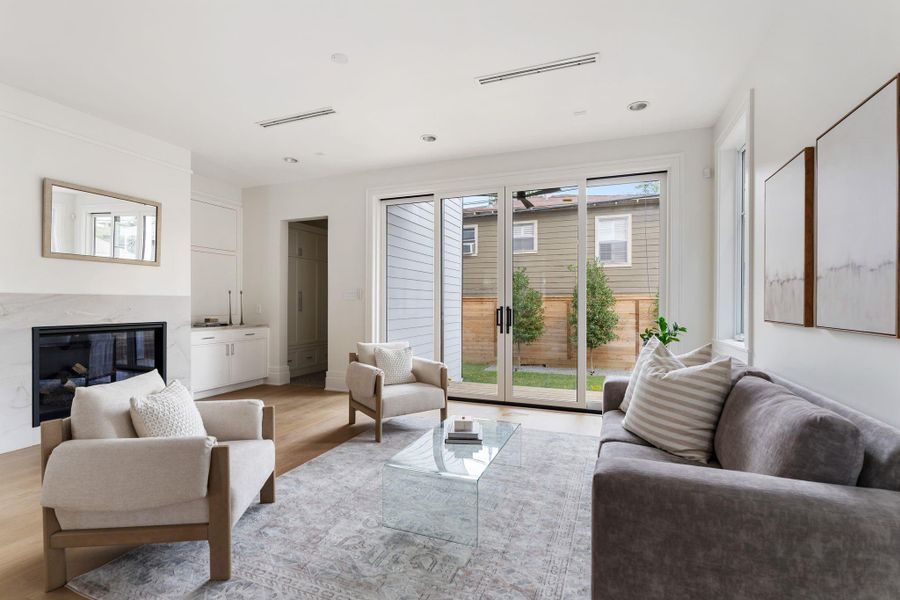 Beautiful oversized glass doors opening to manicured back green space.