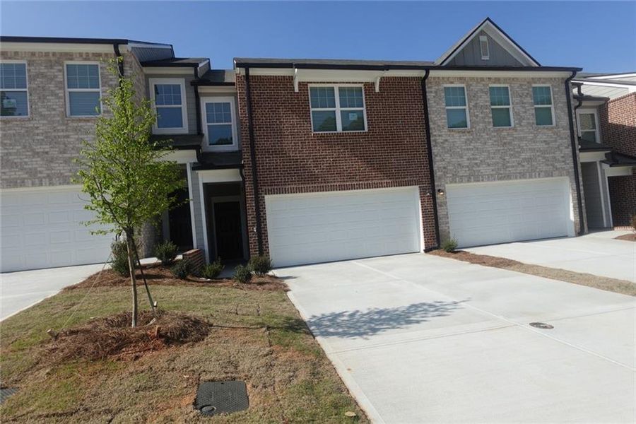 Front exterior of a new home in Kendall Grove, McDonough, GA, highlighting curb appeal (Image 2). Front exterior of a new home in Kendall Grove, McDonough, GA, highlighting curb appeal (Image 2).