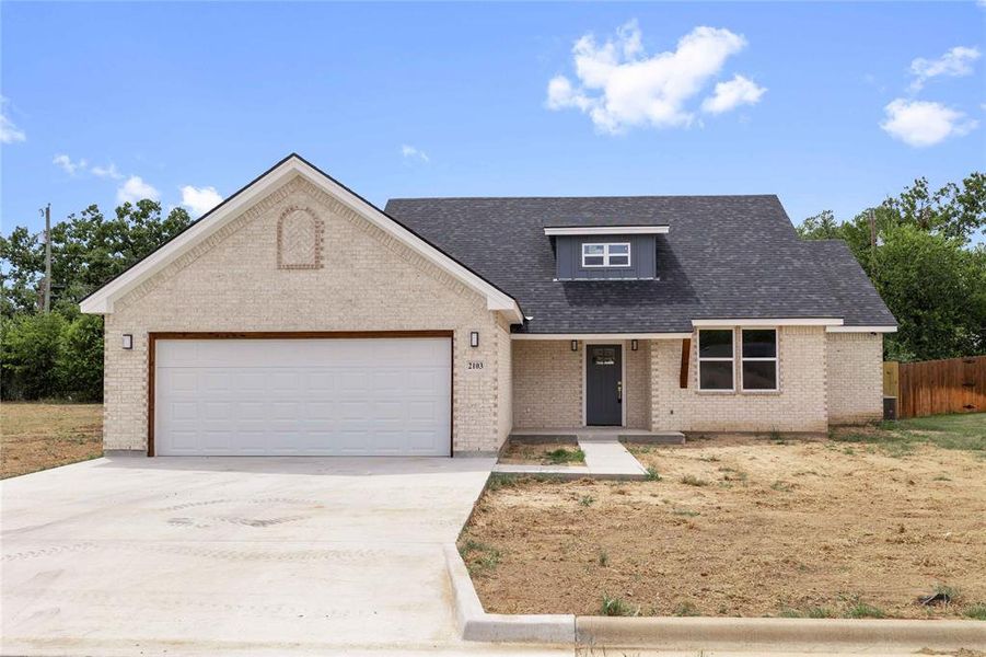 View of front of house with brick siding, concrete driveway, covered porch, an attached garage, and a shingled roof View of front of house with brick siding, concrete driveway, covered porch, an attached garage, and a shingled roof
