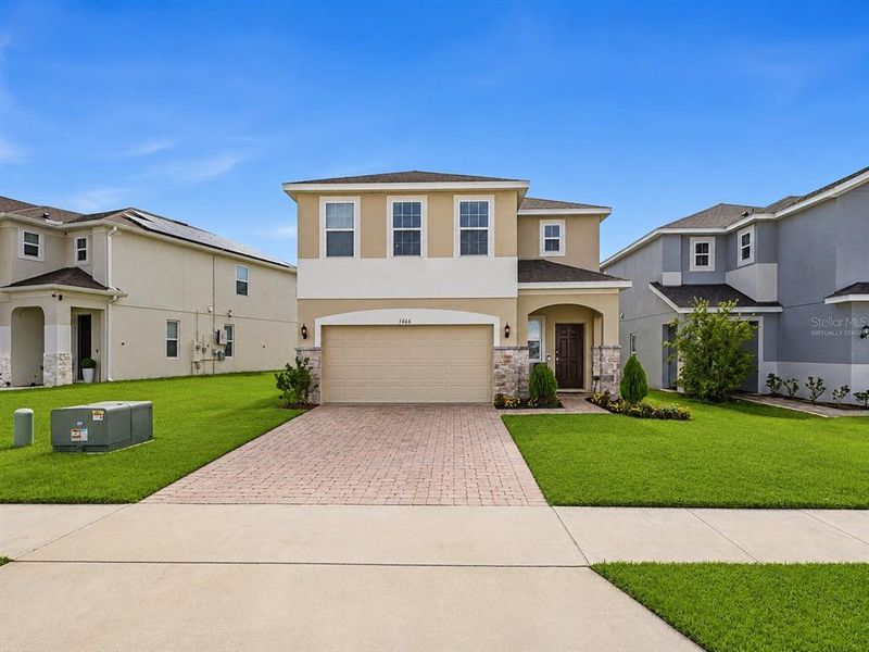 Front exterior of a new home in , Kissimmee, FL, highlighting curb appeal (Image 24). Front exterior of a new home in , Kissimmee, FL, highlighting curb appeal (Image 24).