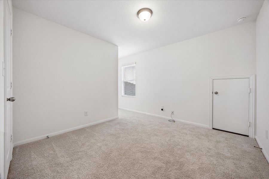Empty room with baseboards and light colored carpet