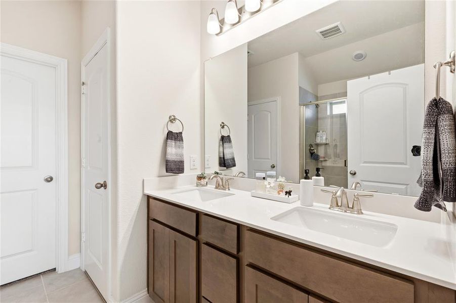 Double vanity featuring two integrated sinks, brushed nickel faucets, and a white countertop