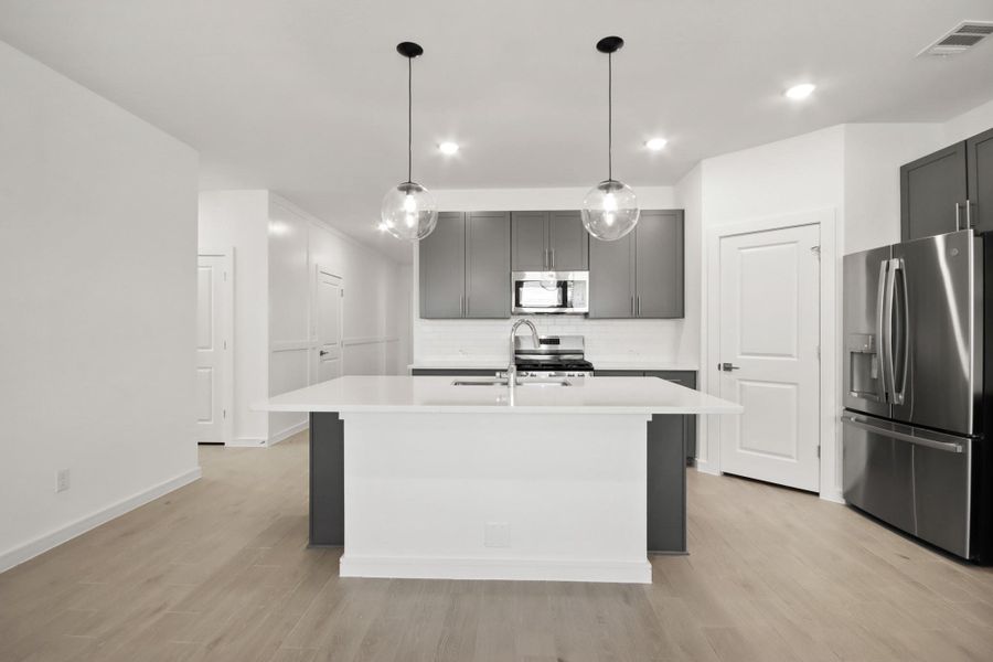 Gorgeous island kitchen with grey cabinets