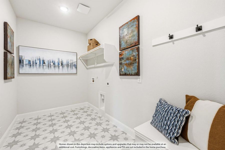Laundry room with patterned tile floor, wall shelf, washer and dryer hookups, and a built-in bench with decorative pillows