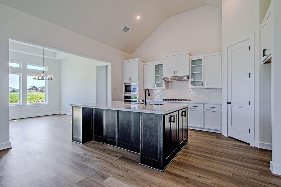 The open-concept kitchen seamlessly connects to the living and dining areas, creating an ideal setting for everyday living and entertaining The open-concept kitchen seamlessly connects to the living and dining areas, creating an ideal setting for everyday living and entertaining