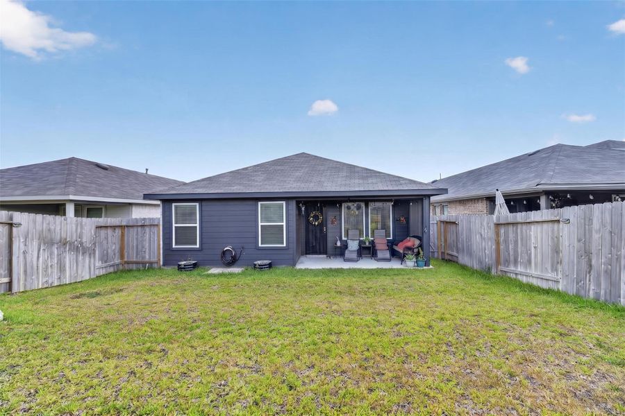 Rear view of the home showcases the generous fenced backyard and open lawn with plenty of possibilities for creating your own outdoor retreat. Rear view of the home showcases the generous fenced backyard and open lawn with plenty of possibilities for creating your own outdoor retreat.