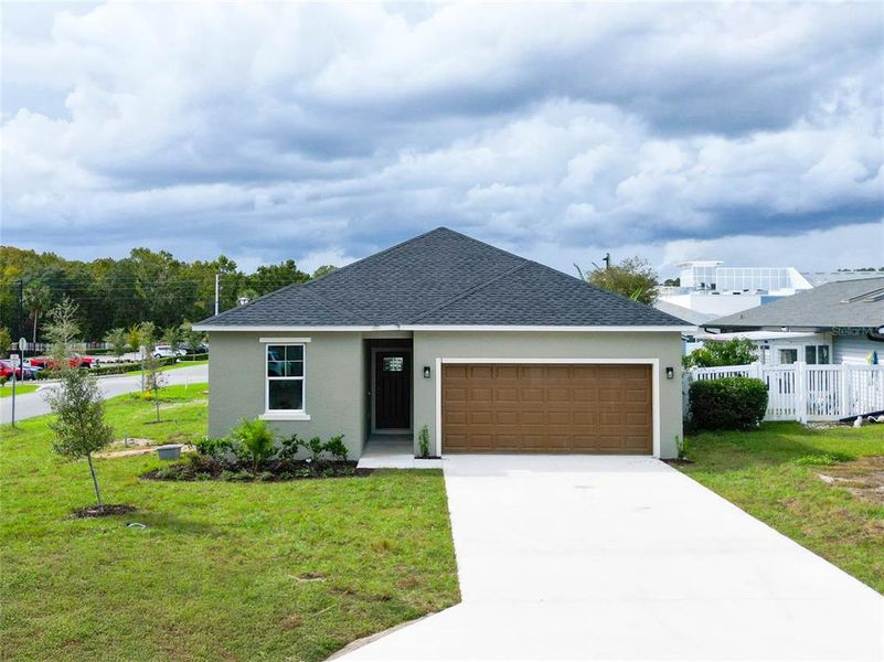 Front exterior of a new home in , Leesburg, FL, highlighting curb appeal (Image 1). Front exterior of a new home in , Leesburg, FL, highlighting curb appeal (Image 1).